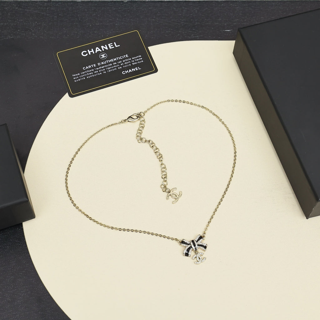 Black gold iridescent enamel bow necklace