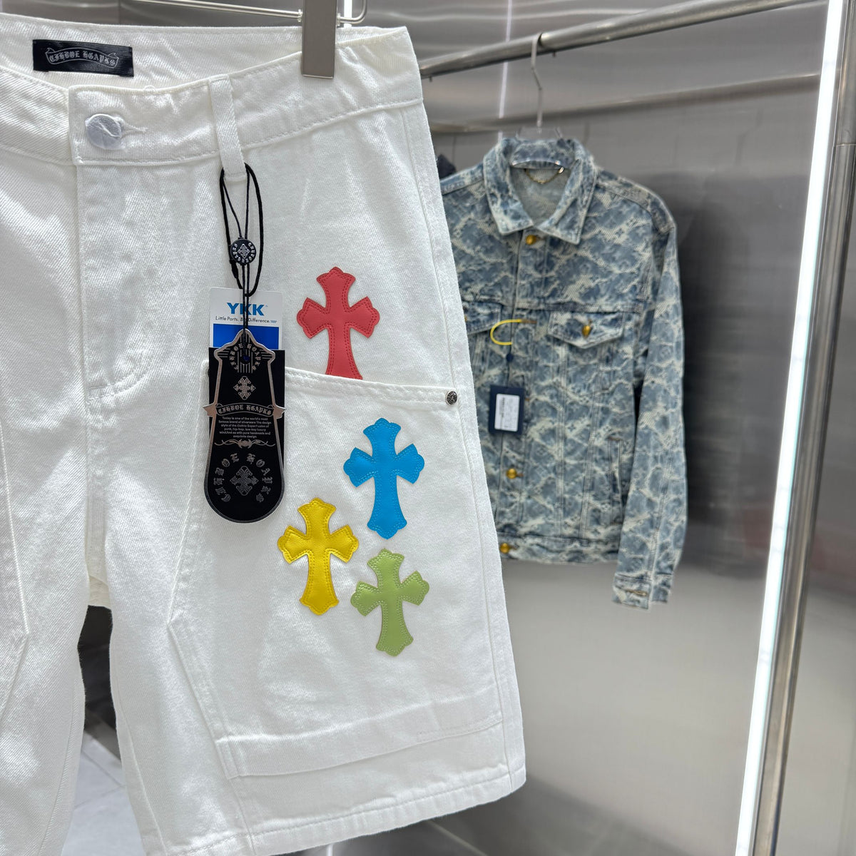Embroidered cross denim shorts with torn holes