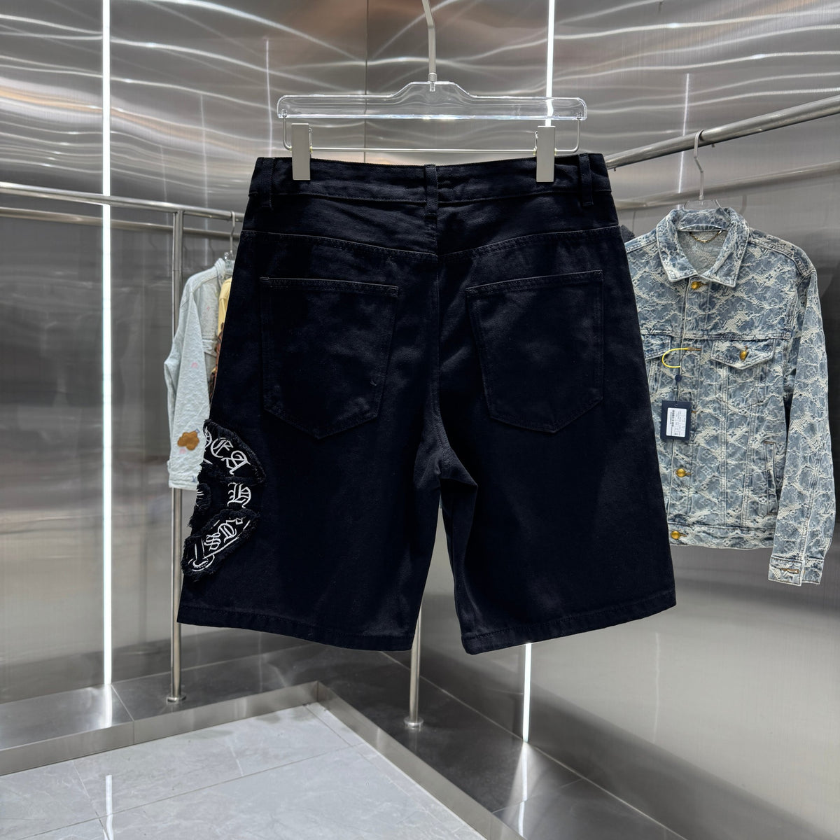 Embroidered cross denim shorts with torn holes