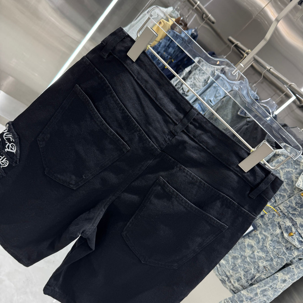 Embroidered cross denim shorts with torn holes