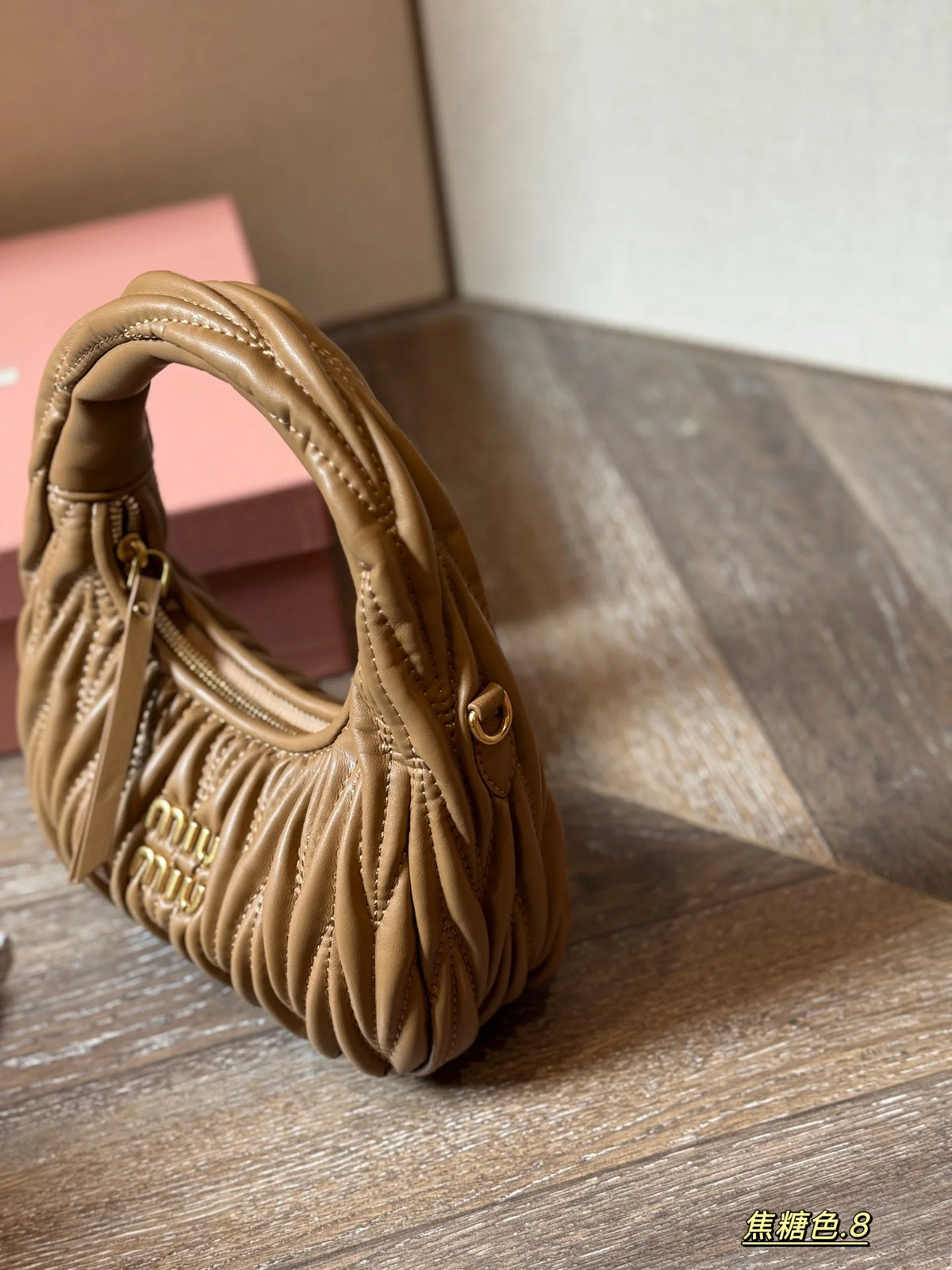Wrist bag with wrinkled crescent shape