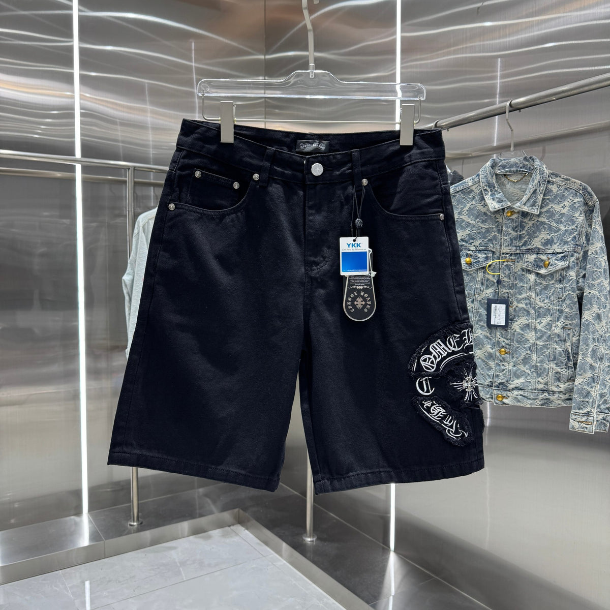 Embroidered cross denim shorts with torn holes
