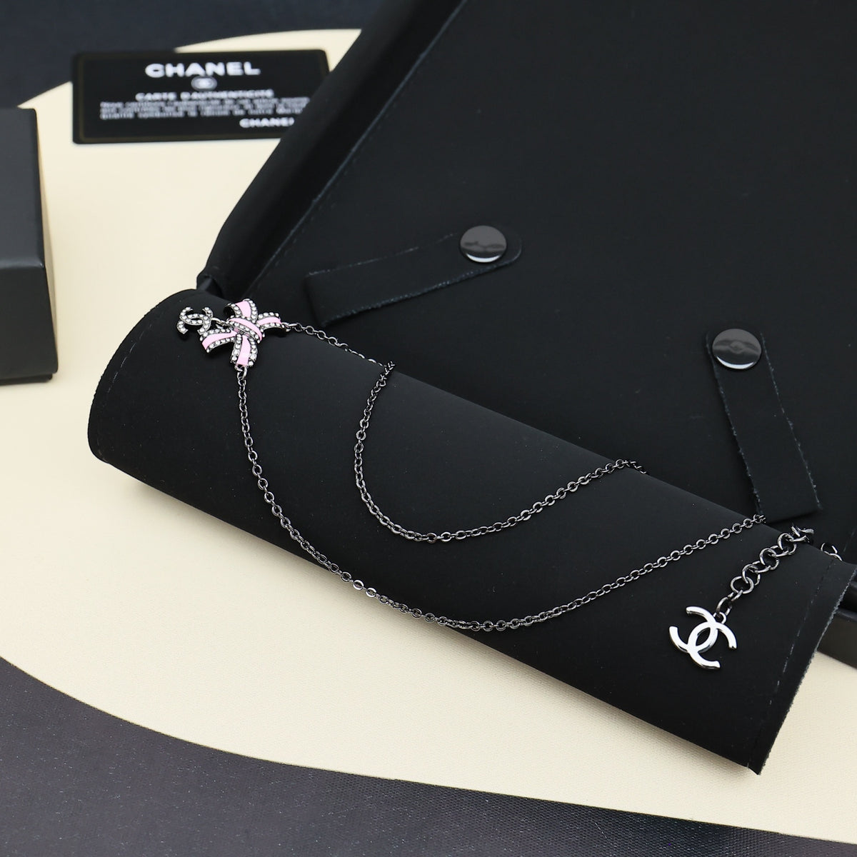 Black gold iridescent enamel bow necklace