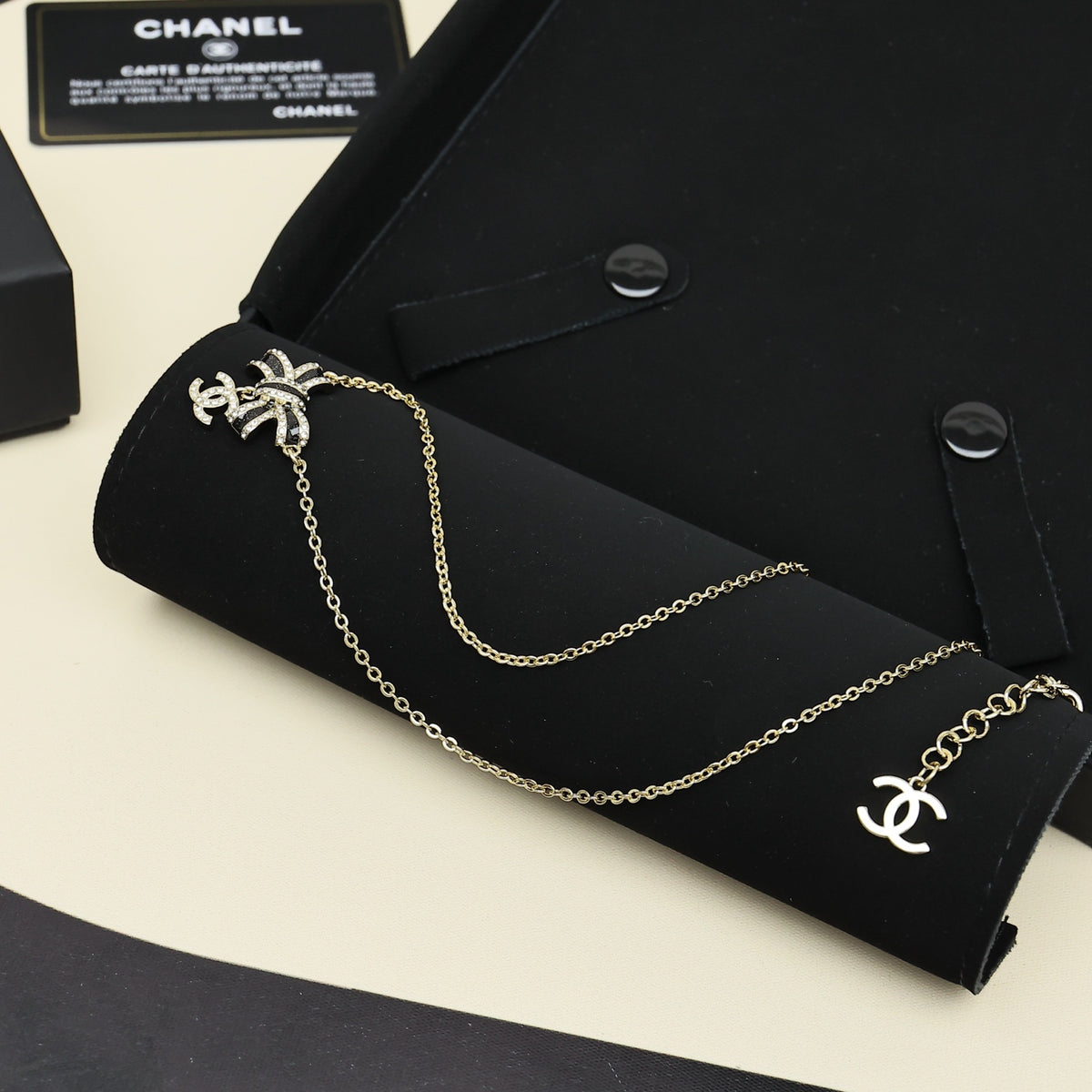 Black gold iridescent enamel bow necklace