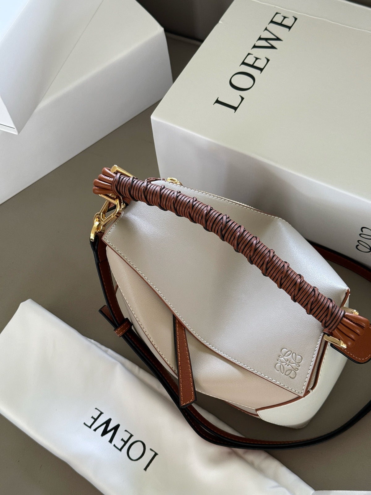 Woven handle, color blocked geometric bag, cowhide