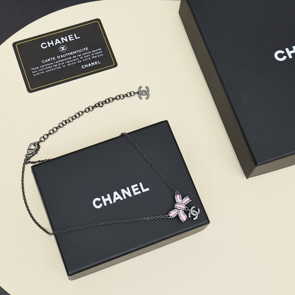 Black gold iridescent enamel bow necklace