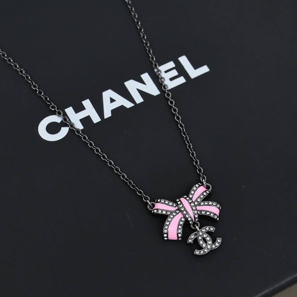 Black gold iridescent enamel bow necklace
