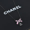 Black gold iridescent enamel bow necklace