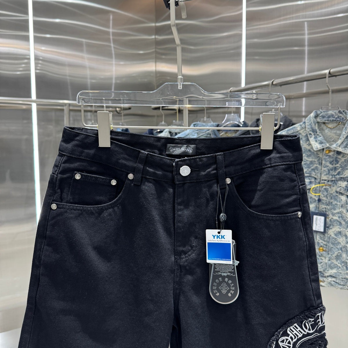 Embroidered cross denim shorts with torn holes