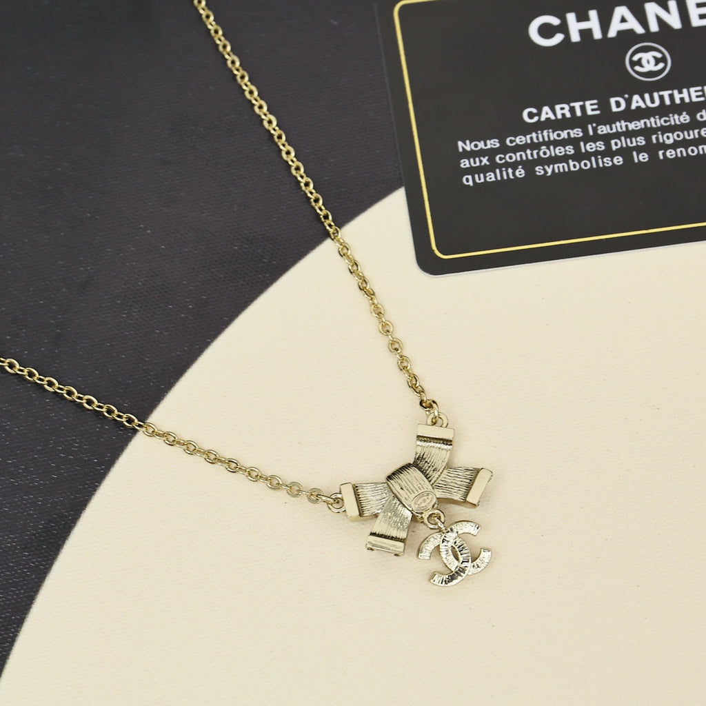 Black gold iridescent enamel bow necklace