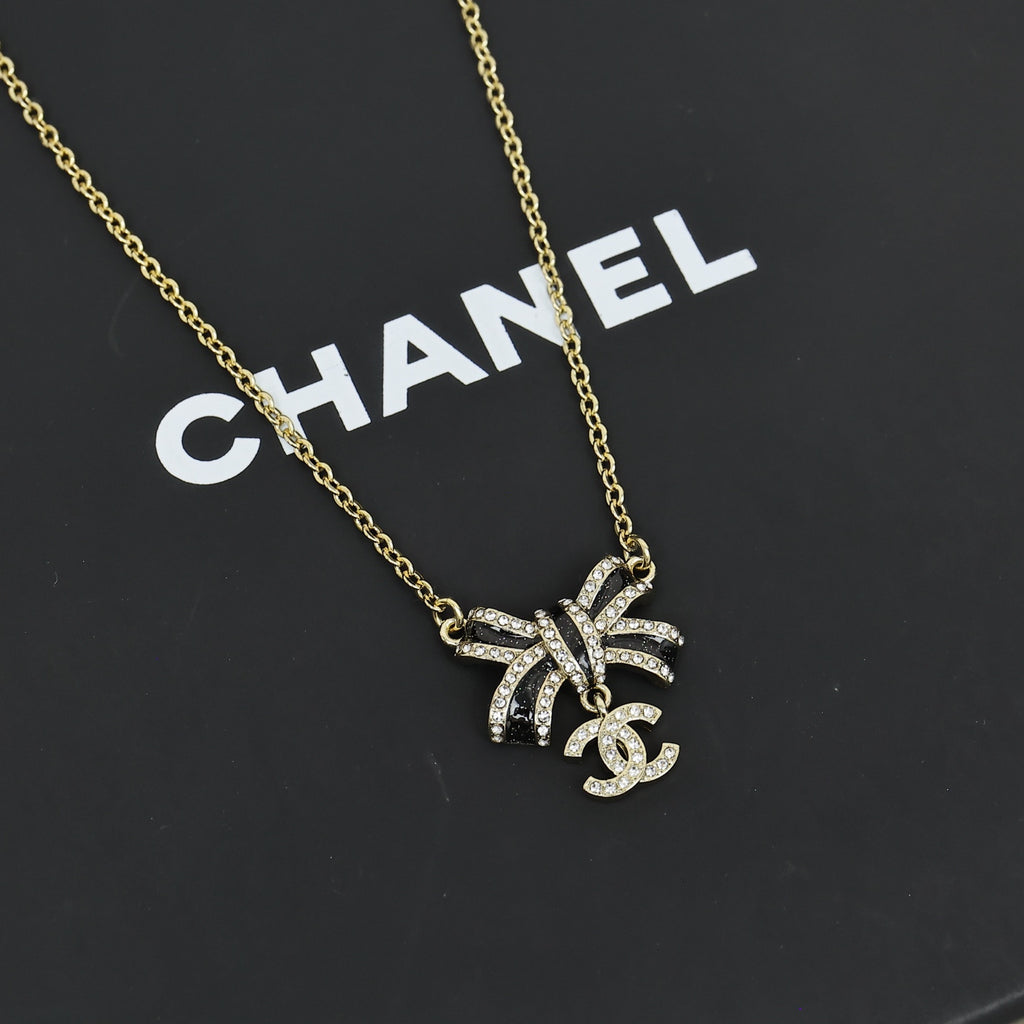 Black gold iridescent enamel bow necklace