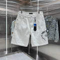 Embroidered cross denim shorts with torn holes