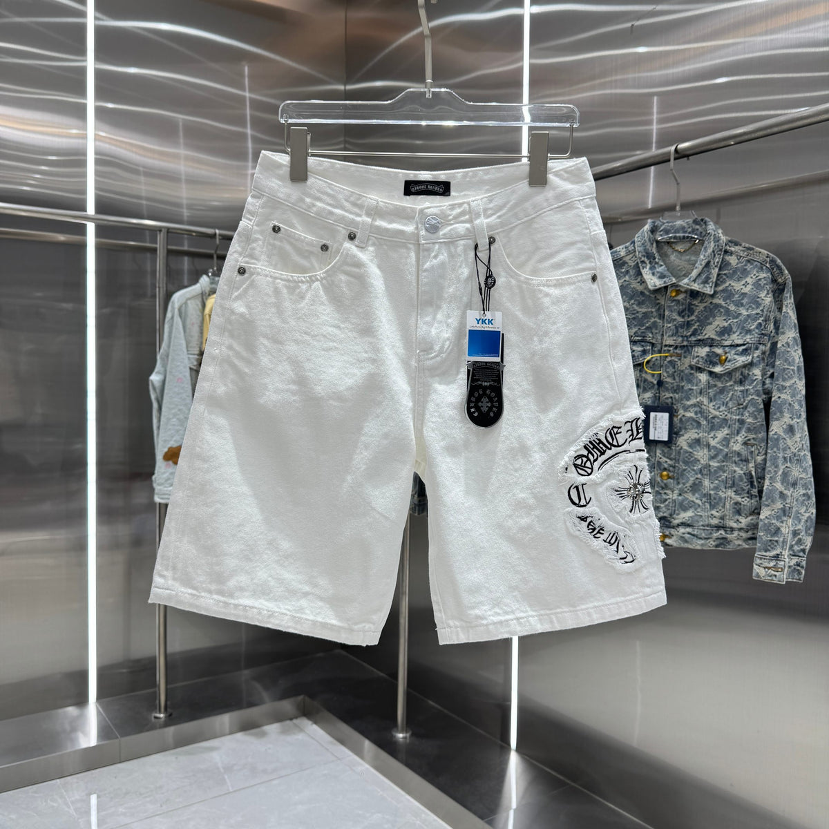 Embroidered cross denim shorts with torn holes