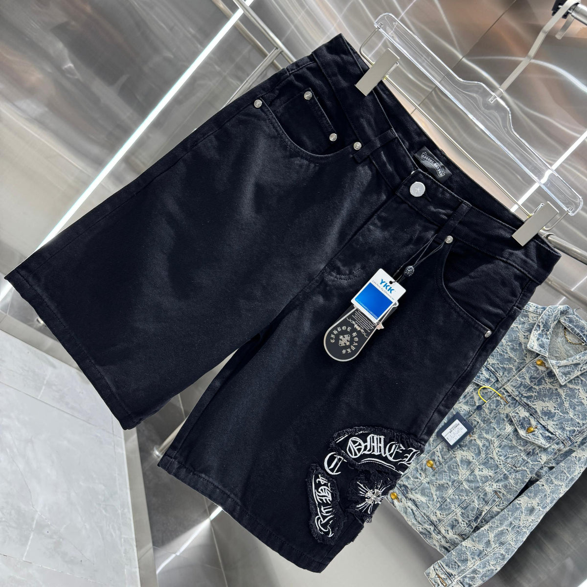 Embroidered cross denim shorts with torn holes