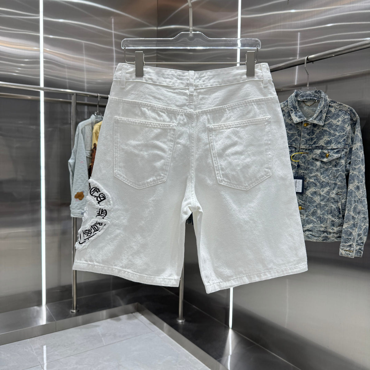 Embroidered cross denim shorts with torn holes
