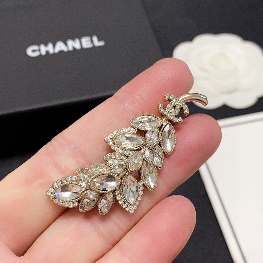 logo brooch